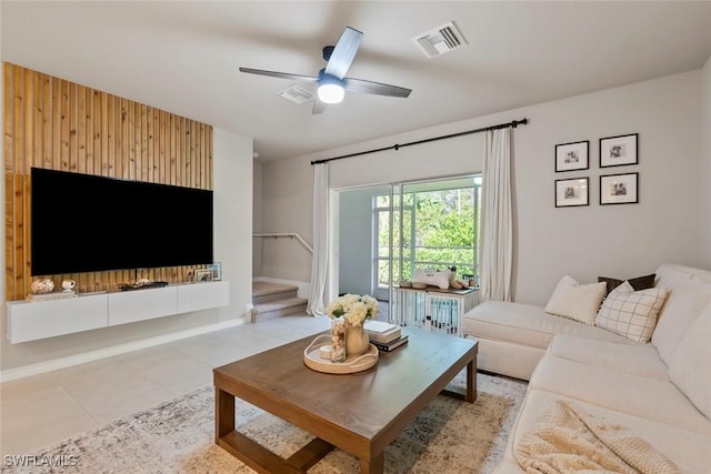 tiled living room with ceiling fan