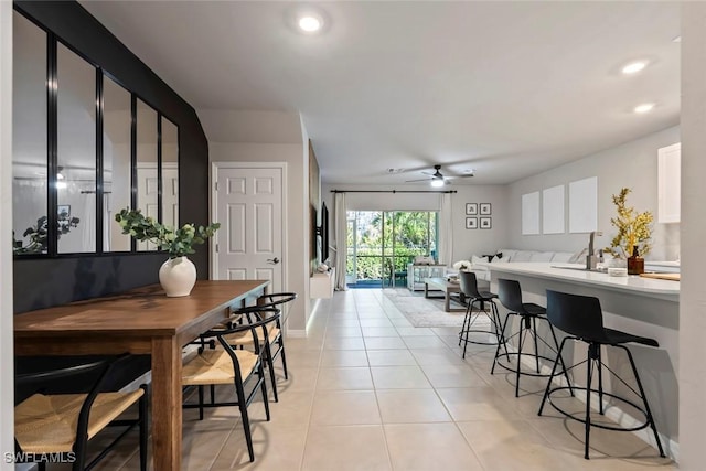 tiled dining area with ceiling fan