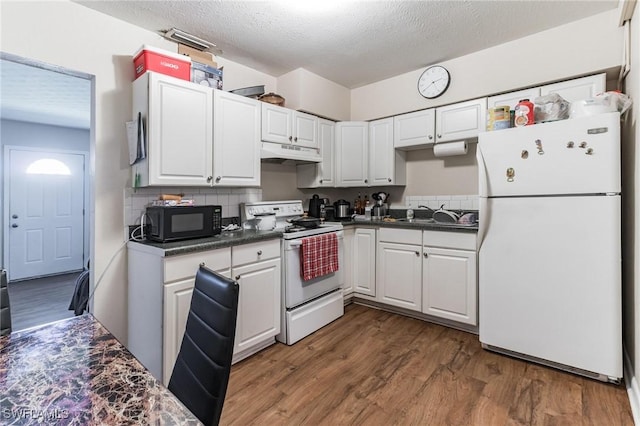 kitchen with sink, white cabinets, dark hardwood / wood-style flooring, white appliances, and a textured ceiling