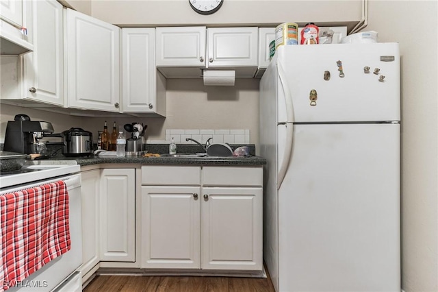 kitchen with white cabinetry, white appliances, dark wood-type flooring, and sink