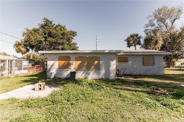 rear view of property featuring a yard