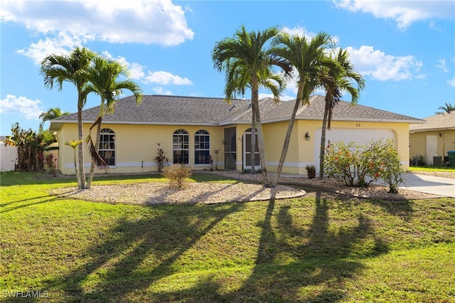 view of front of property with a garage and a front yard