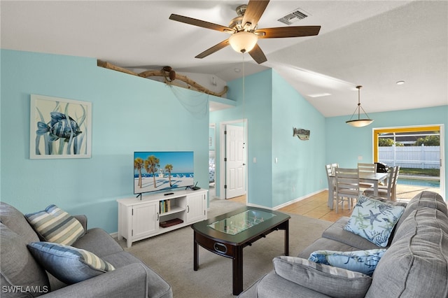 living room featuring ceiling fan, lofted ceiling, and light carpet