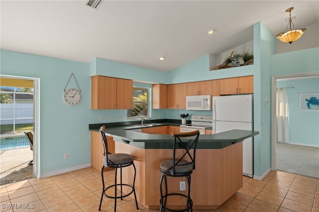 kitchen featuring light tile patterned flooring, pendant lighting, sink, a center island, and white appliances