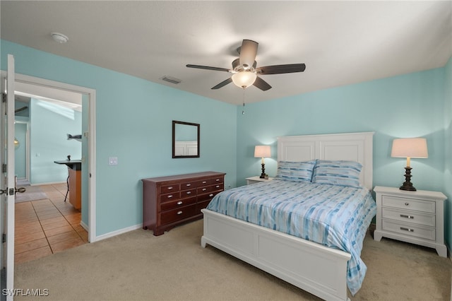 bedroom with light carpet and ceiling fan