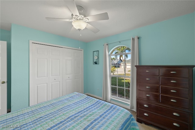 carpeted bedroom featuring a closet and ceiling fan