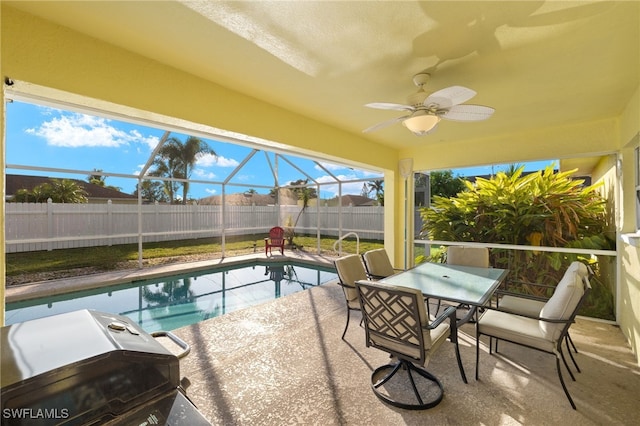 view of pool featuring a patio, ceiling fan, and glass enclosure