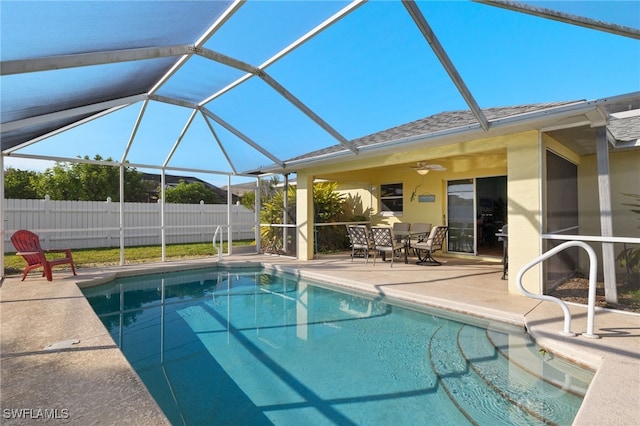 view of pool featuring a lanai, a patio, and ceiling fan