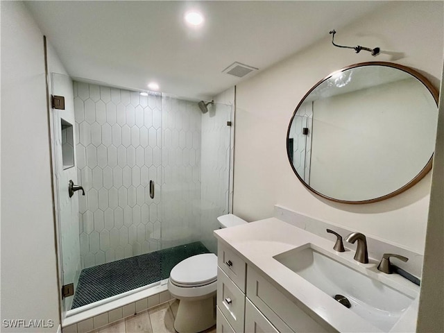 bathroom with vanity, an enclosed shower, and toilet