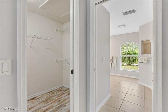 spacious closet featuring light tile patterned floors