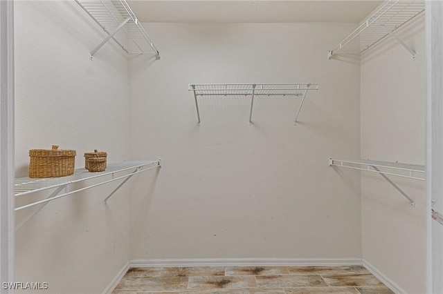 spacious closet featuring light hardwood / wood-style flooring