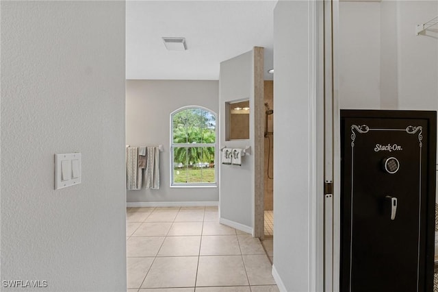 hall featuring light tile patterned floors