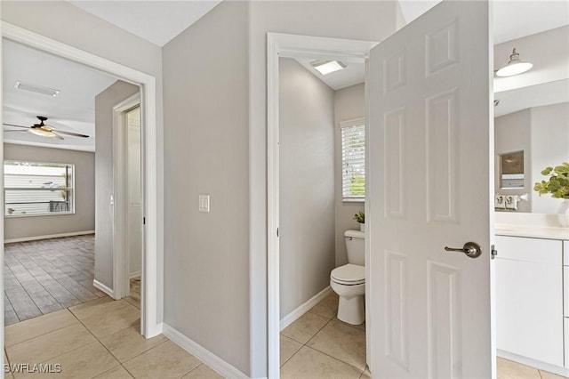 bathroom featuring tile patterned flooring, a wealth of natural light, and toilet