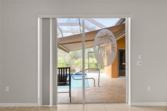 doorway with light tile patterned flooring and lofted ceiling