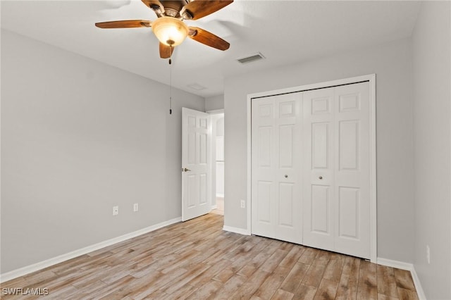 unfurnished bedroom featuring a closet, ceiling fan, and light hardwood / wood-style flooring