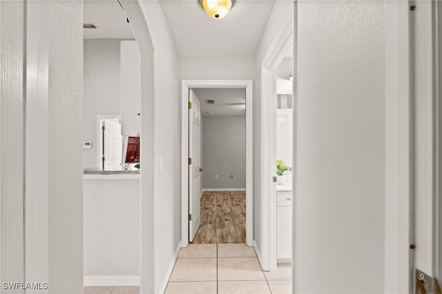 hallway with light tile patterned floors