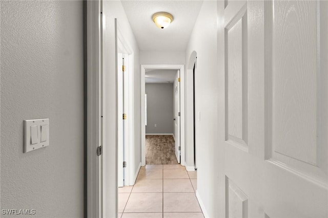 hall with light tile patterned flooring