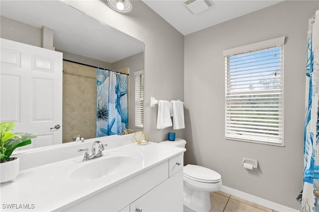 bathroom featuring tile patterned flooring, vanity, curtained shower, and toilet