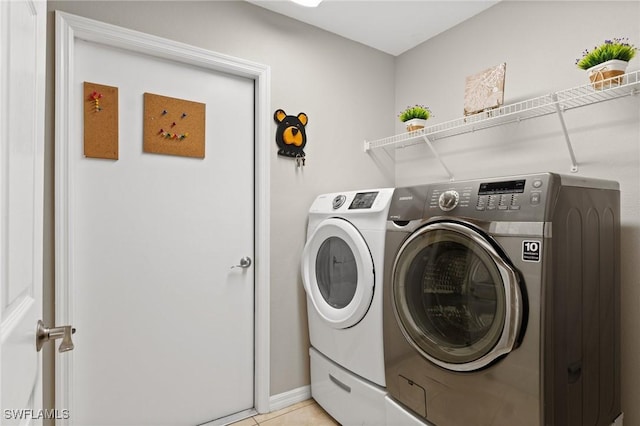 laundry room with light tile patterned flooring and separate washer and dryer