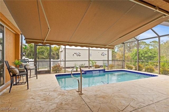 view of swimming pool with glass enclosure and a patio area