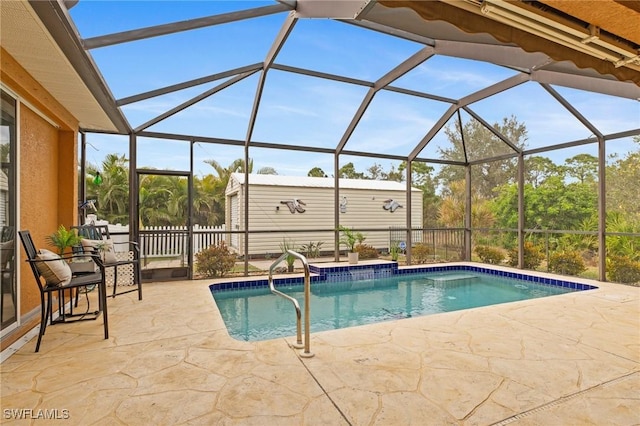 view of pool with a patio area and glass enclosure