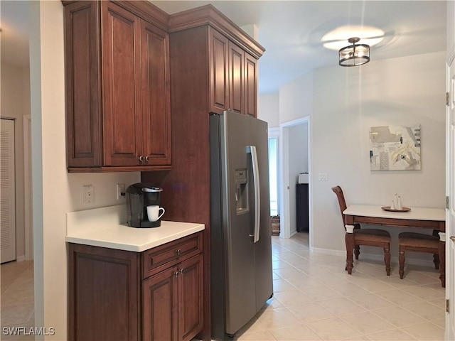 kitchen featuring light tile patterned floors and stainless steel fridge