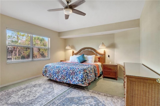 bedroom with ceiling fan, carpet flooring, and baseboards