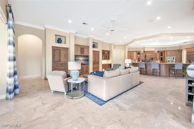 living room featuring ceiling fan and ornamental molding