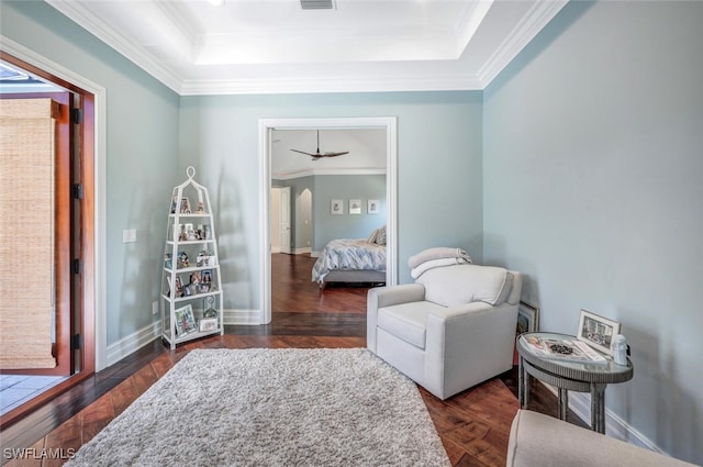 living area featuring ornamental molding, dark hardwood / wood-style flooring, and a tray ceiling