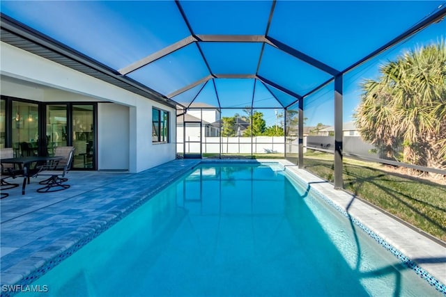 view of swimming pool featuring a lanai and a patio