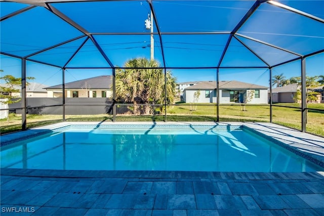 view of pool with a yard and a lanai