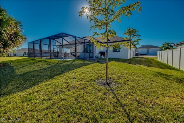 view of yard featuring a lanai and central air condition unit