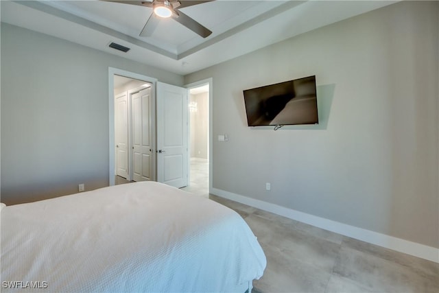 bedroom featuring a raised ceiling and ceiling fan