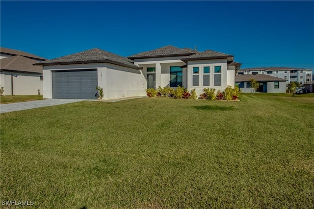 prairie-style house with a garage and a front lawn