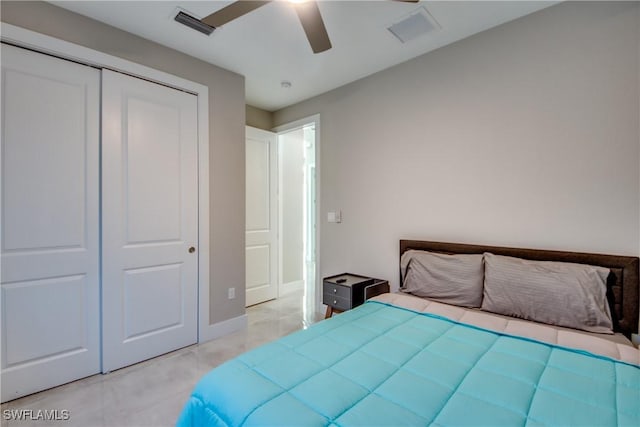 tiled bedroom featuring ceiling fan and a closet