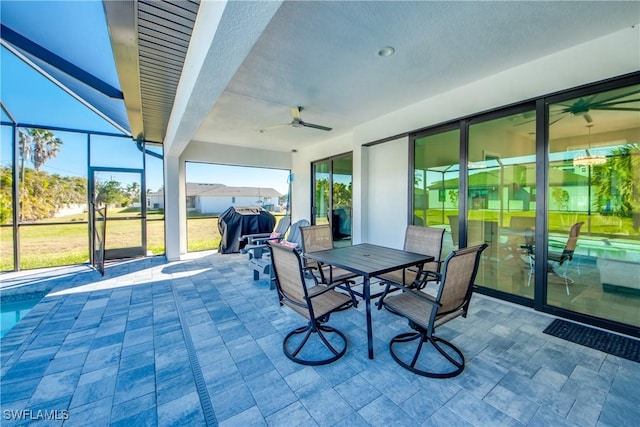 sunroom / solarium featuring ceiling fan