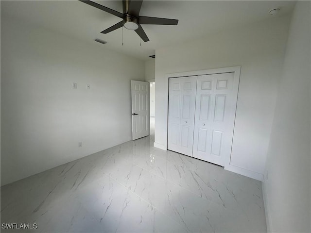 unfurnished bedroom featuring a closet and ceiling fan