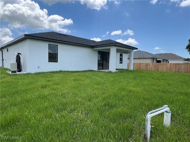 rear view of property with a yard