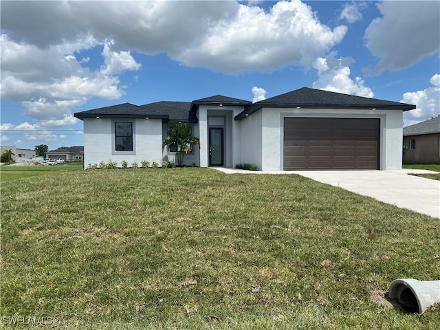 view of front of property featuring a garage and a front yard