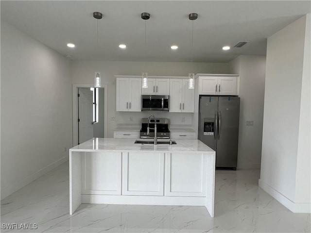 kitchen featuring pendant lighting, sink, white cabinets, and appliances with stainless steel finishes