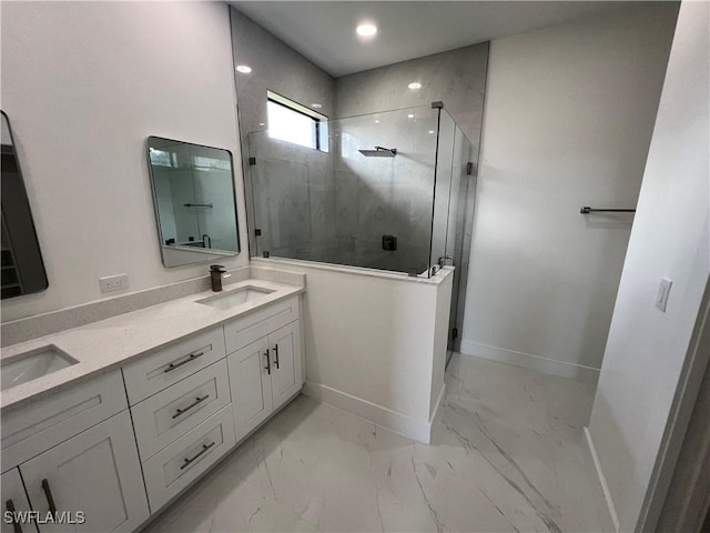 bathroom with vanity and a shower with door