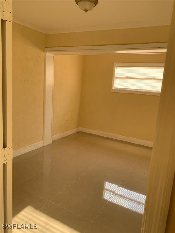 unfurnished room with tile patterned floors