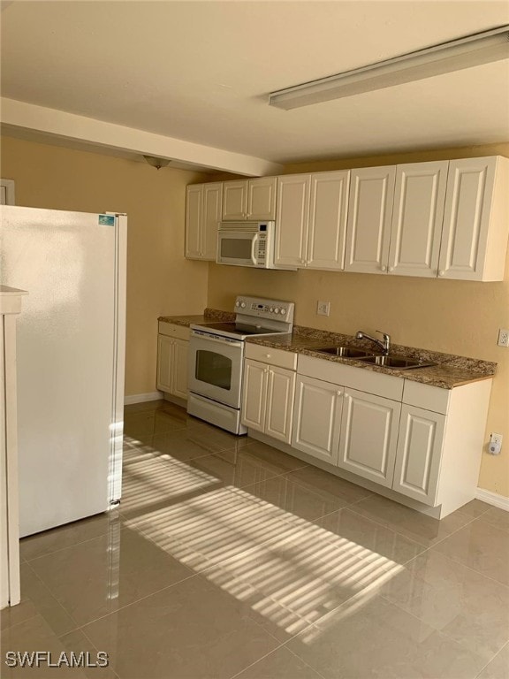 kitchen with light tile patterned floors and white appliances