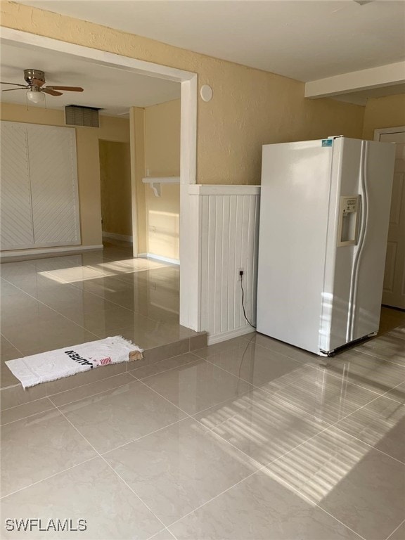 spare room with light tile patterned flooring and ceiling fan