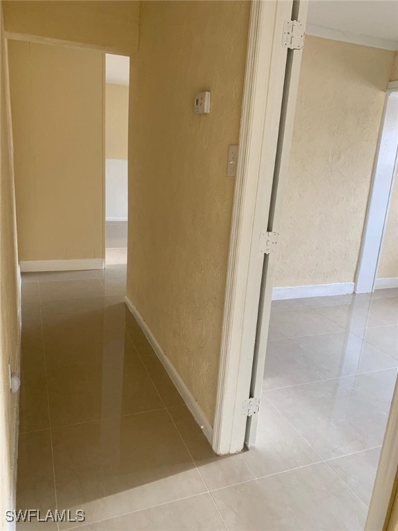 corridor featuring light tile patterned floors