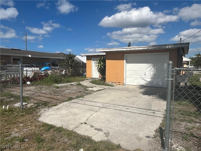 view of front of property with a garage and an outdoor structure