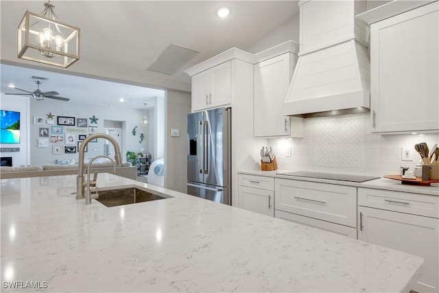 kitchen with white cabinetry, sink, high end refrigerator, custom exhaust hood, and black electric stovetop