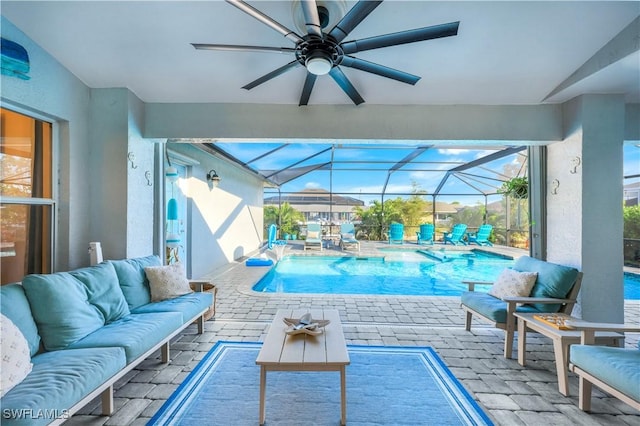 view of pool with outdoor lounge area, a patio, and glass enclosure