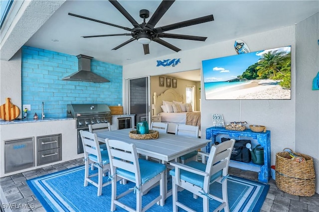 view of patio / terrace with ceiling fan, an outdoor kitchen, a grill, and sink