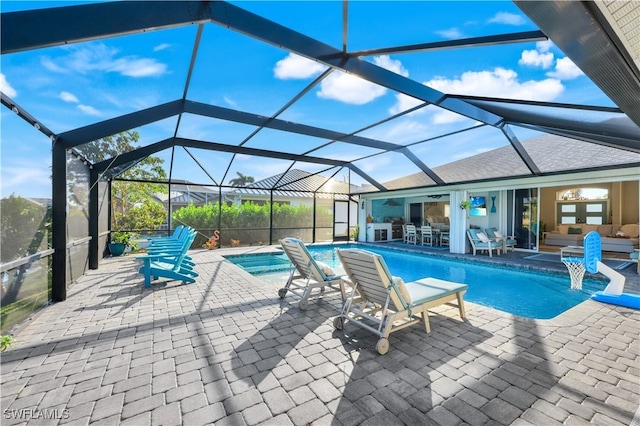 view of swimming pool featuring an outdoor living space, a patio, ceiling fan, and glass enclosure